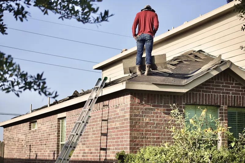 Professional roofer working on a residential roof in Pear Tree Village